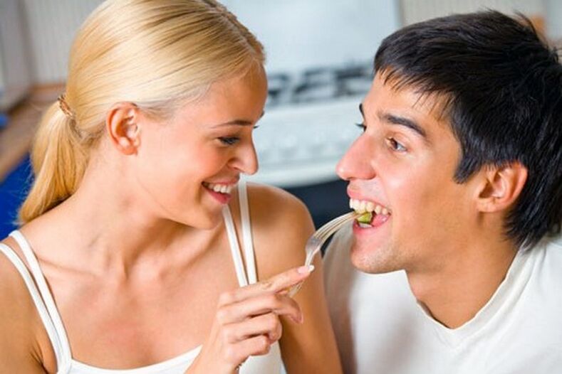 the woman feeds the man products to stimulate potency